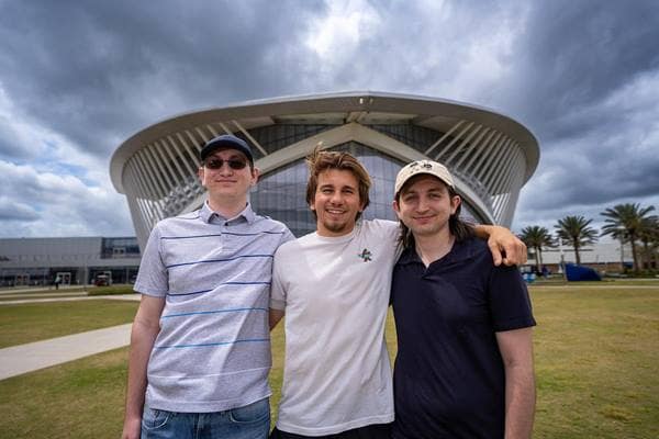 The Troxler brothers — Connor, Corey and Casey — pose in front of the Mori Hosseini Student Union