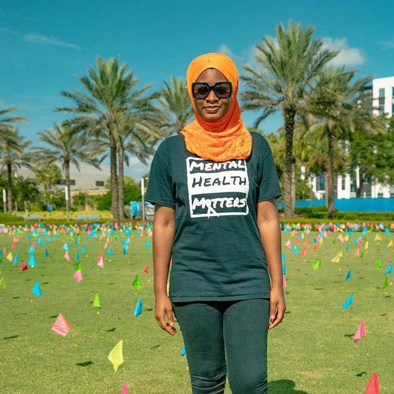 A female student wears a hijab and Mental Health Matters shirt at a suicide prevention event.