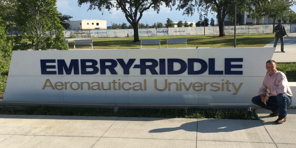 During a visit to the Daytona Beach Campus, Eagle alum and grad student Chase Trissel poses next to the Embry-Riddle sign. (Photo: Chase Trissel)