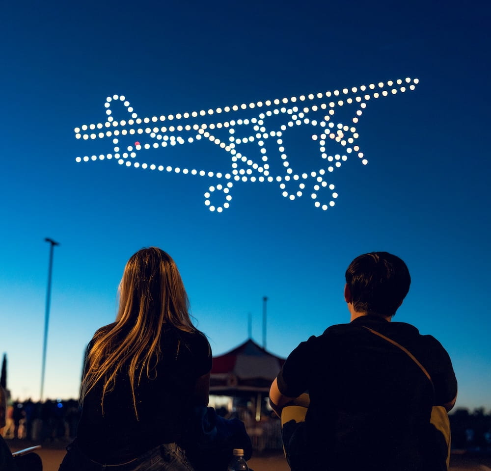 Students looking at plane in sky