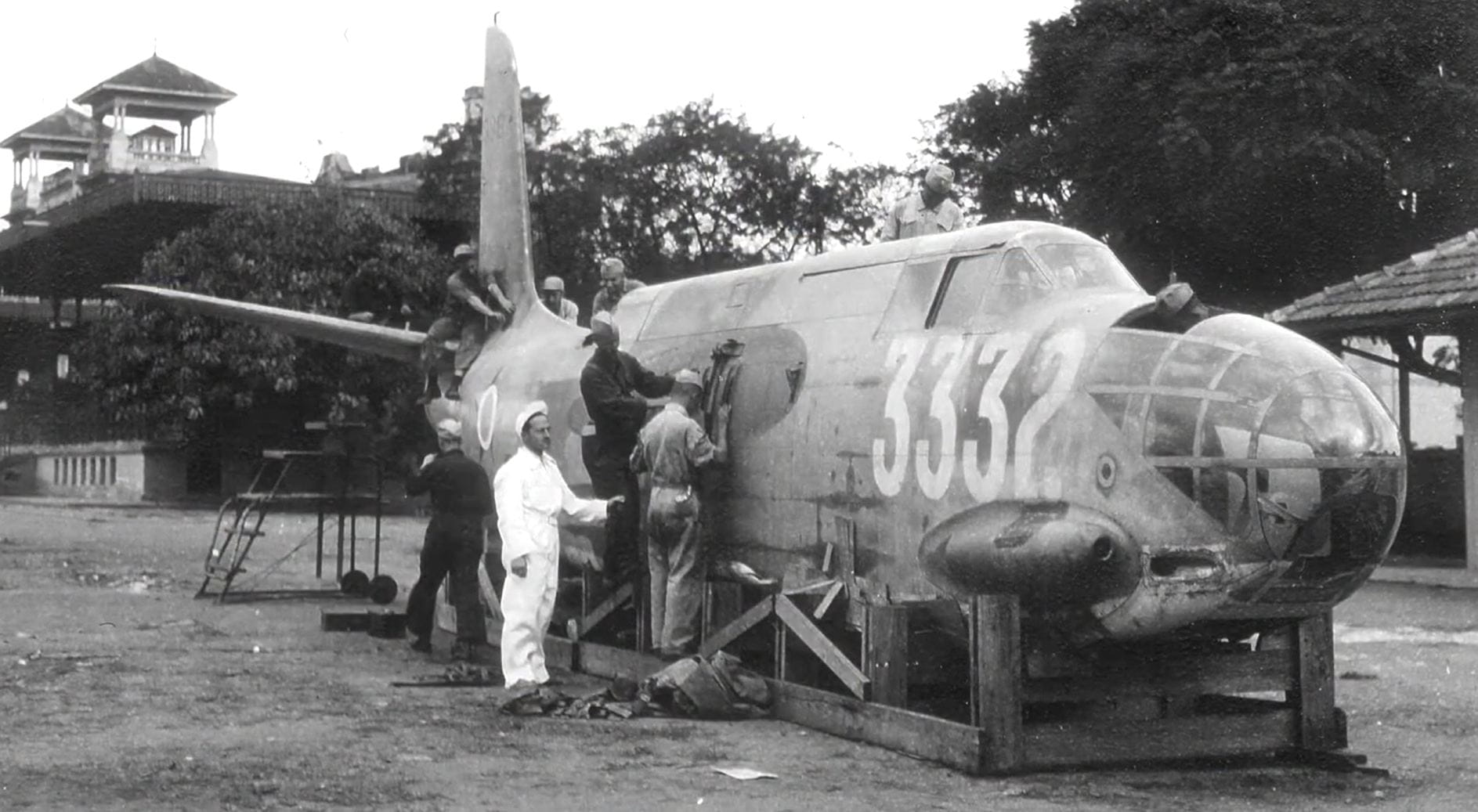 Men work on an old plane.