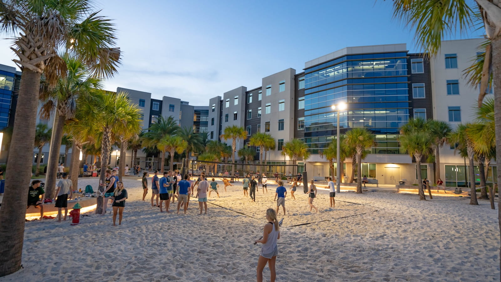 Students playing sand volleyball