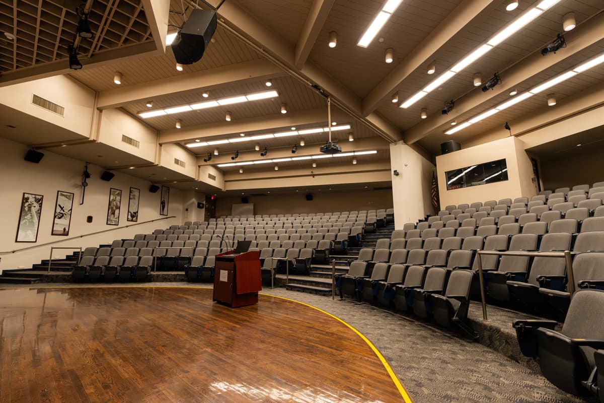A side, stage-level perspective looking toward the seating area of an empty auditorium.