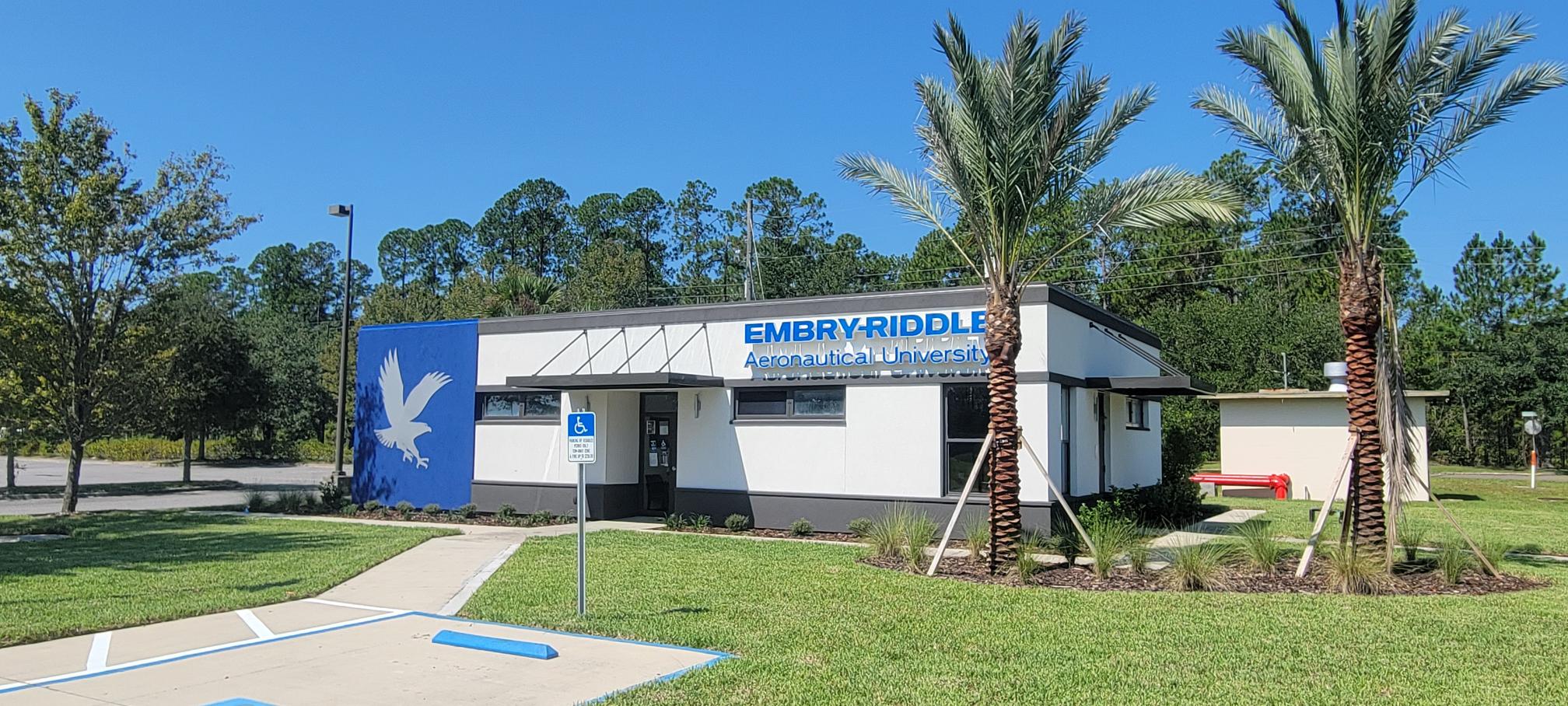 Exterior of the Embry-Riddle building at Jackson Cecil Airport with two palm trees outside