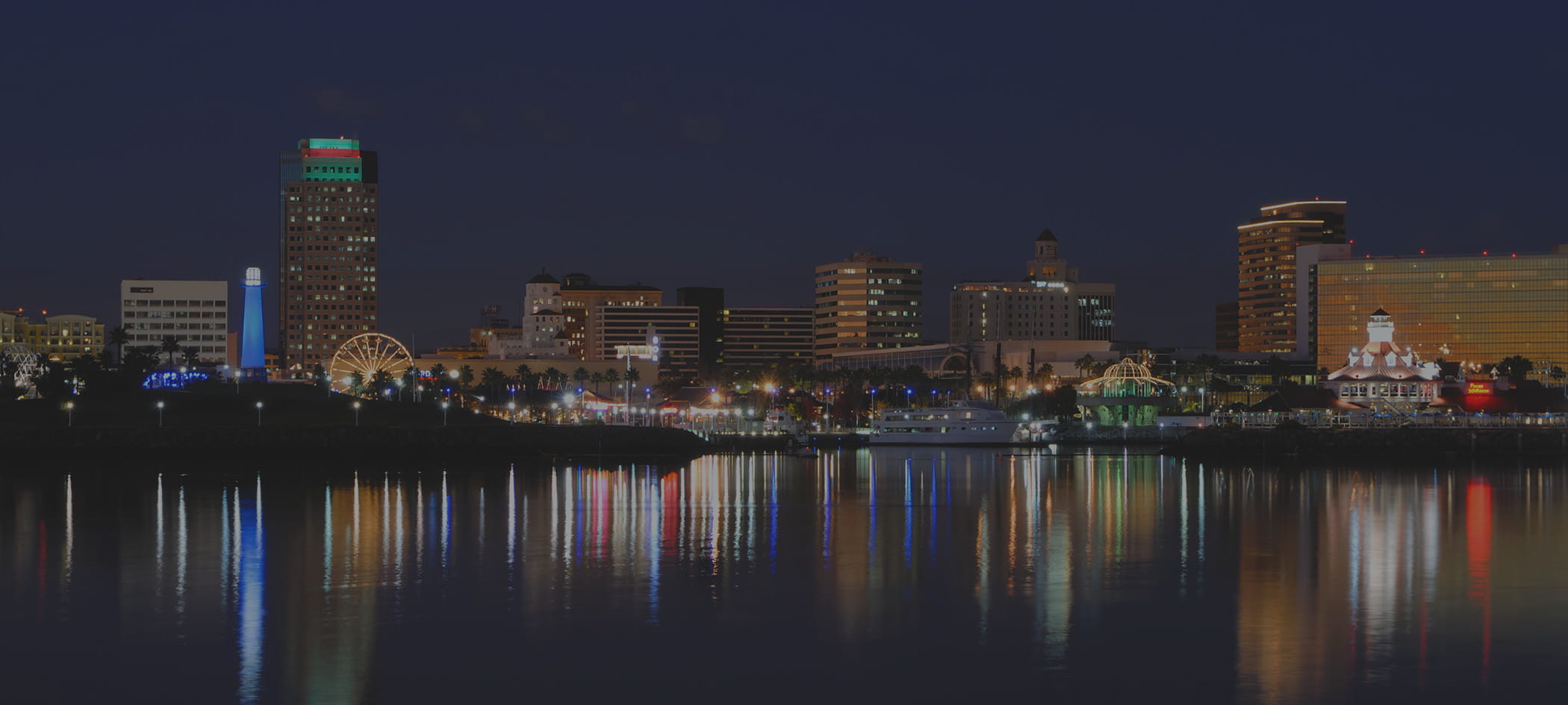 Los Angeles buildings at night next to water.