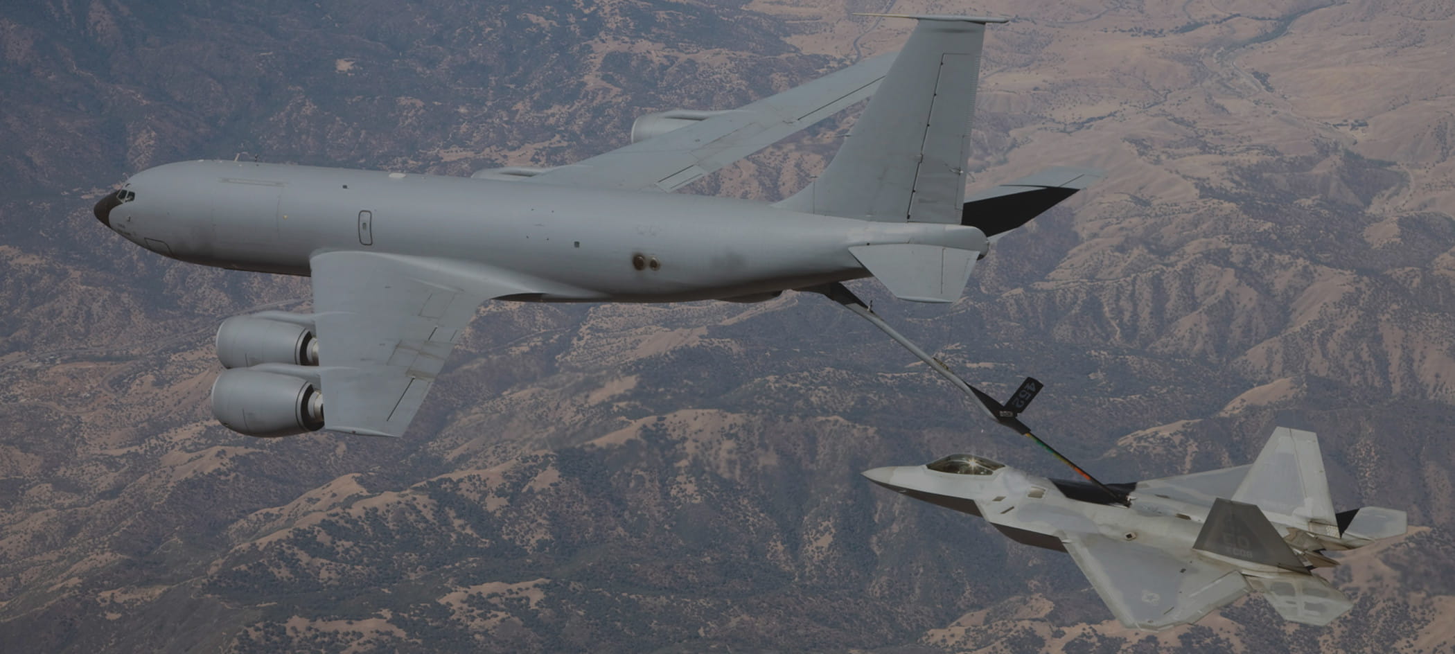 Military cargo plane followed by jet.