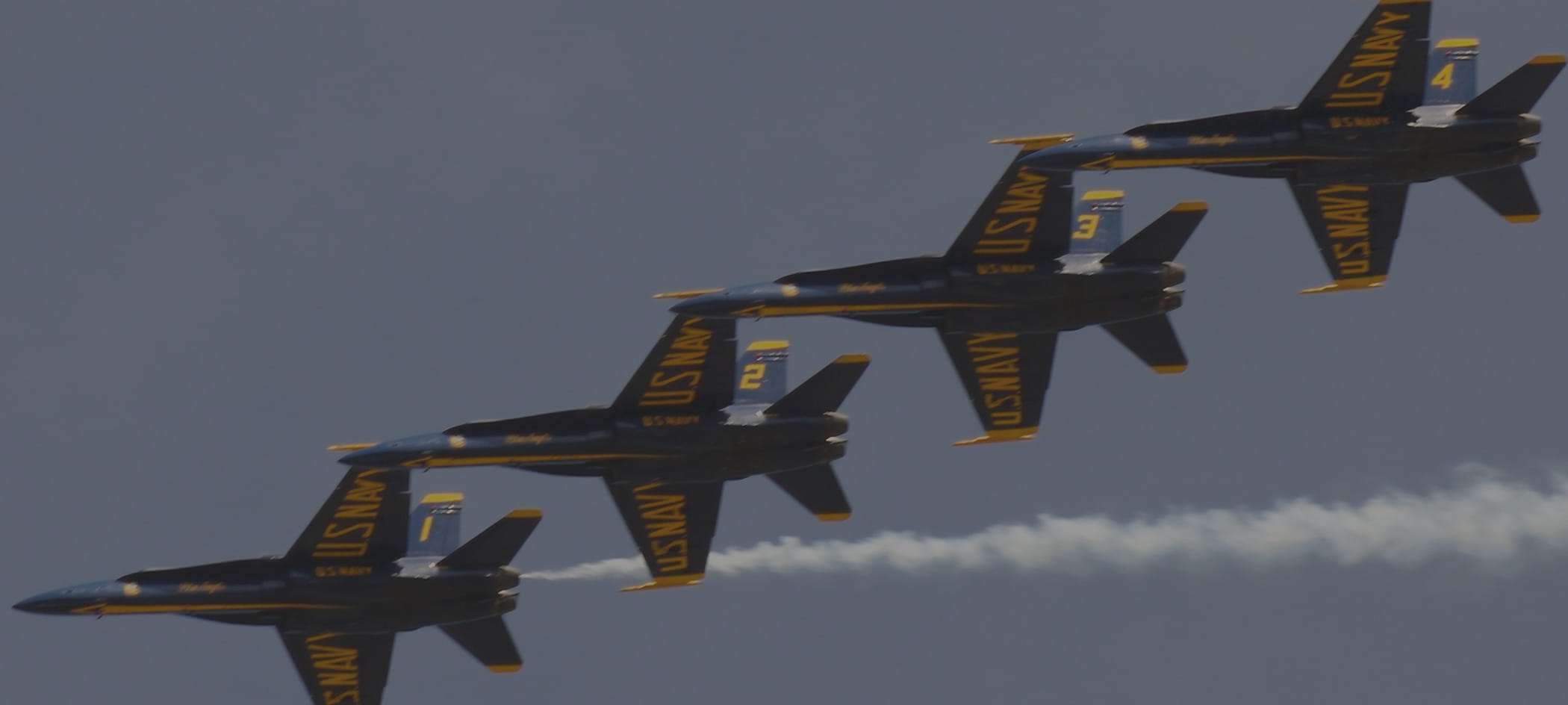 Four fighter jets flying.