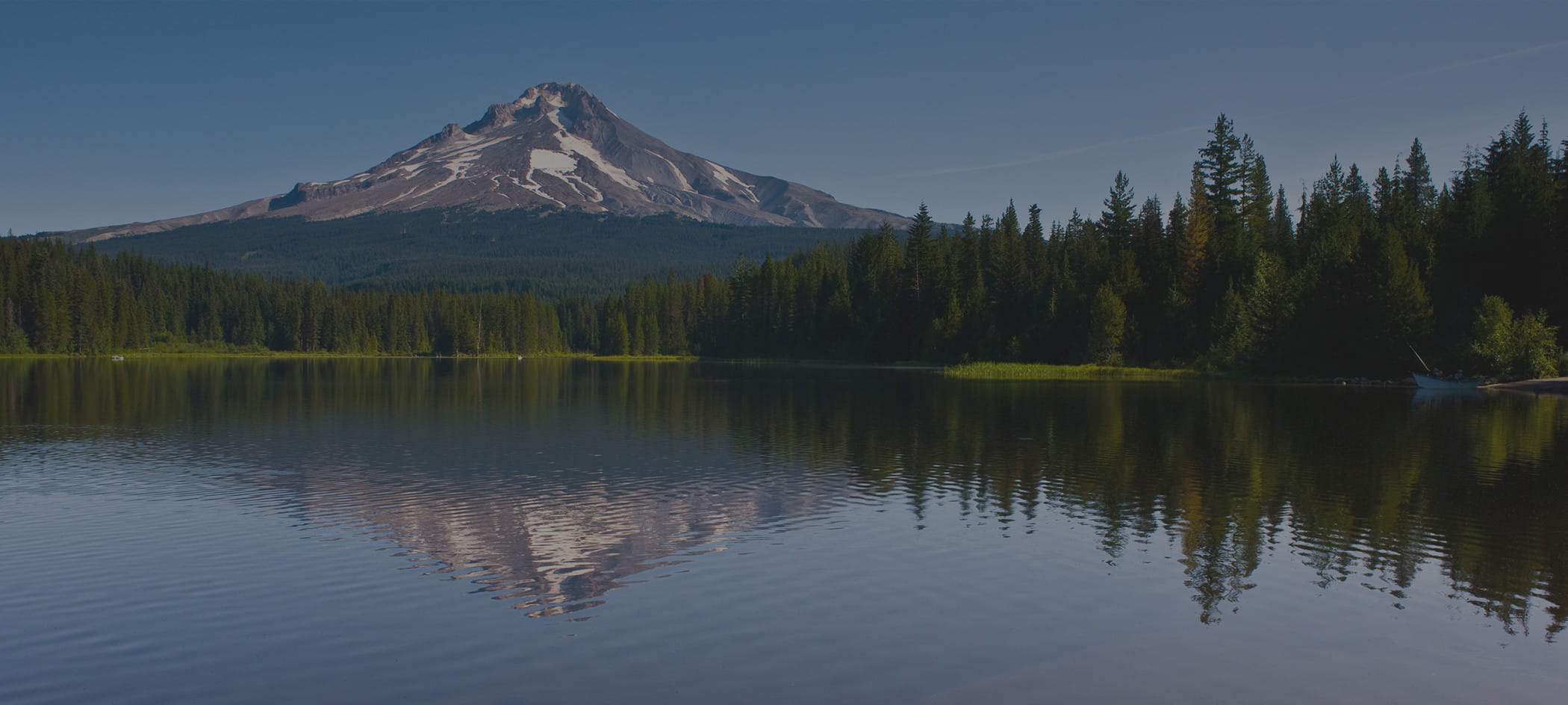A lake with a mountain in the background.