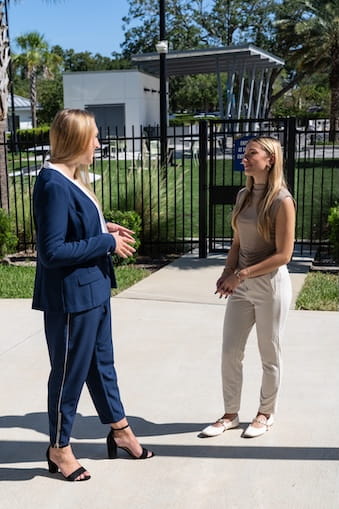 Boeing mentor stands with an Embry-Riddle student outside on campus