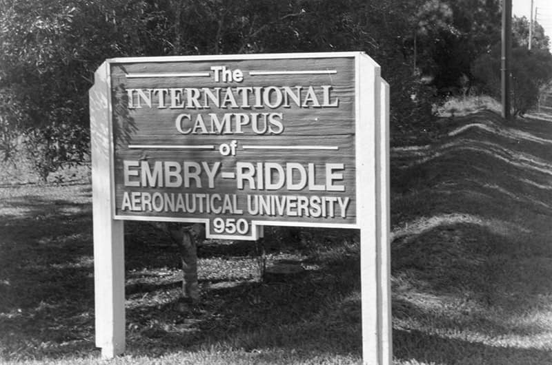 An etched, outdoor sign reads, ‘The International Campus of Embry-Riddle Aeronautical University.'