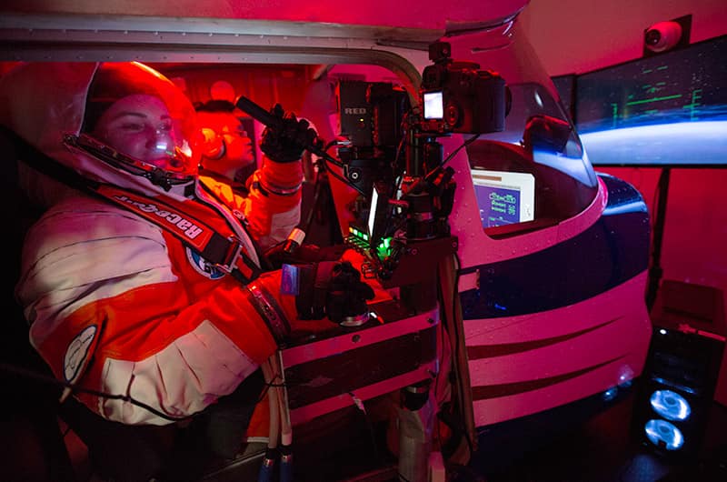 Woman wearing a spacesuit in a simulator.