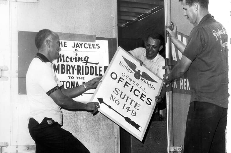 Men load signs into a moving truck.