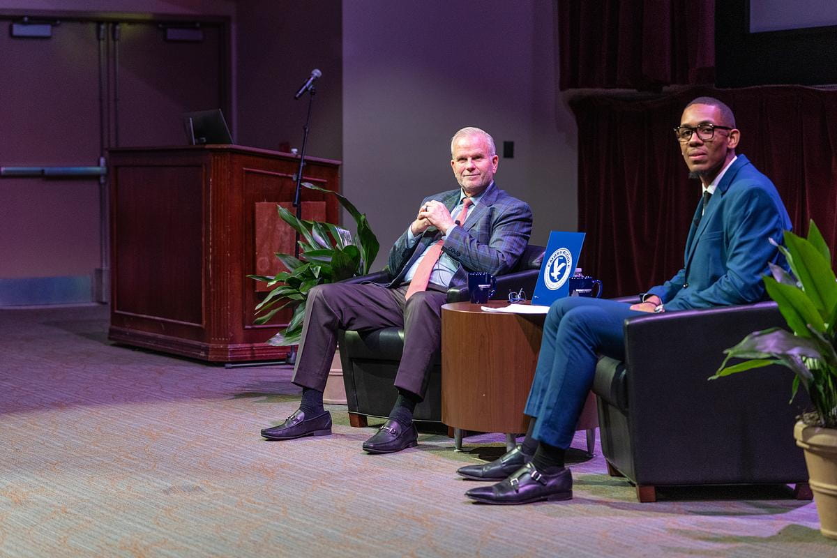 Embry-Riddle student Calvin Freeman speaks with FAA administrator Dan Elwell at a Presidential Speaker Series event.