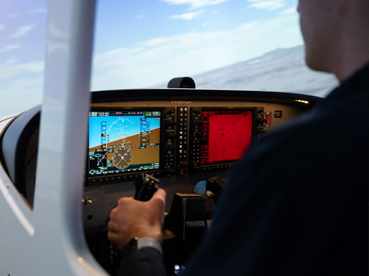 A person using a flight simulator.