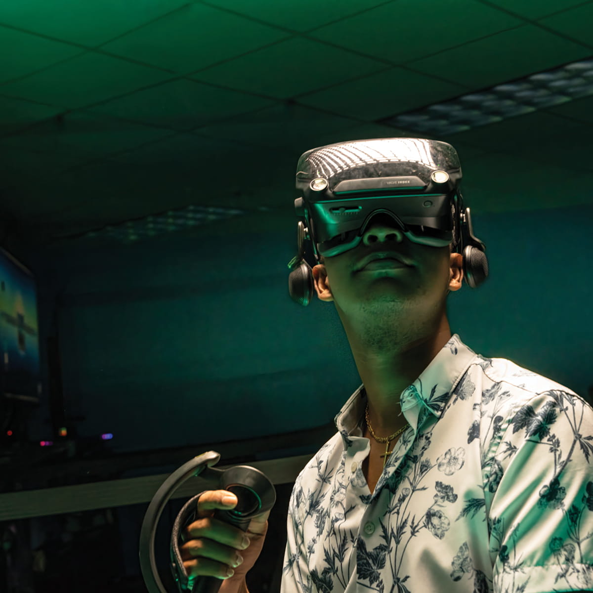 Student wearing augmented reality headset and holding controller during immersive simulation in lab environment.