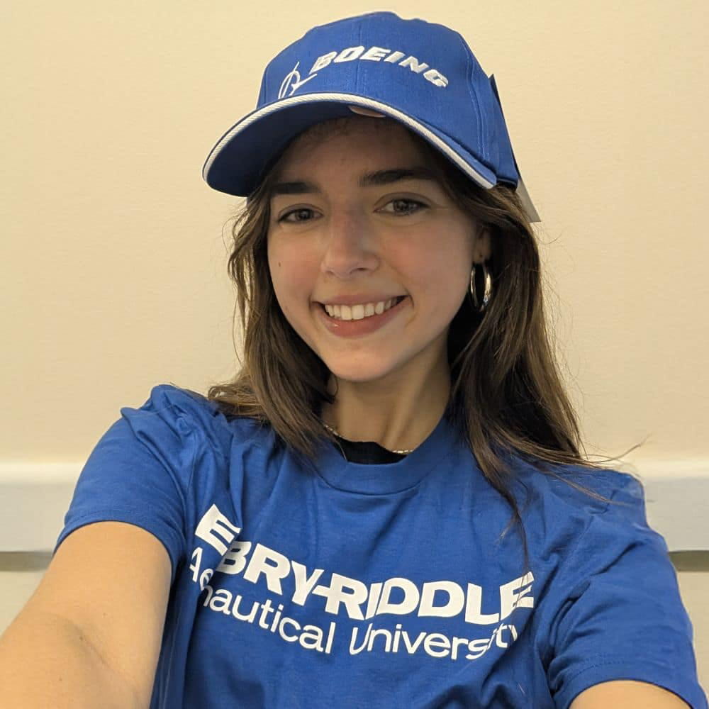 Katherina Steiner stands wearing an Embry-Riddle shirt and Boeing hat
