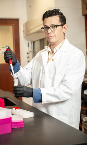 Professor measures chemicals.