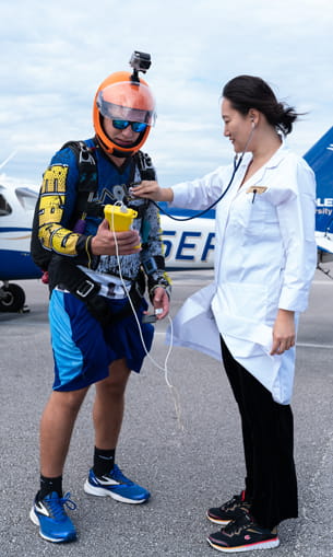 Skydiver's vitals checked after a jump.