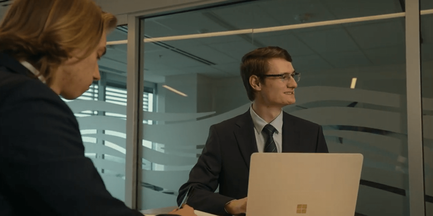 Embry-Riddle student sits in a conference room on a laptop