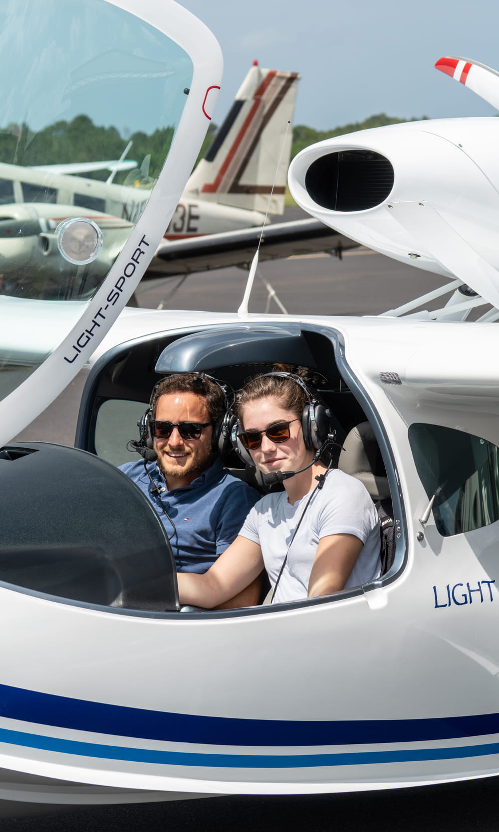 Woman and man in a small plane.