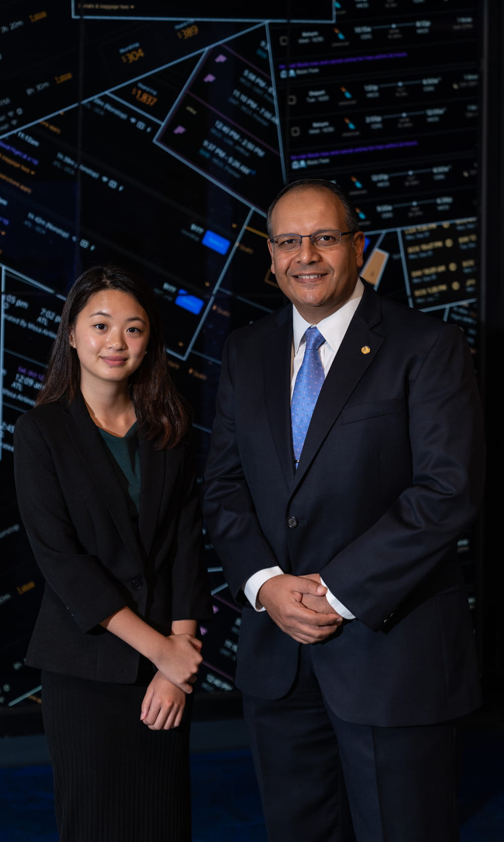 Man and woman in front of business graphic.