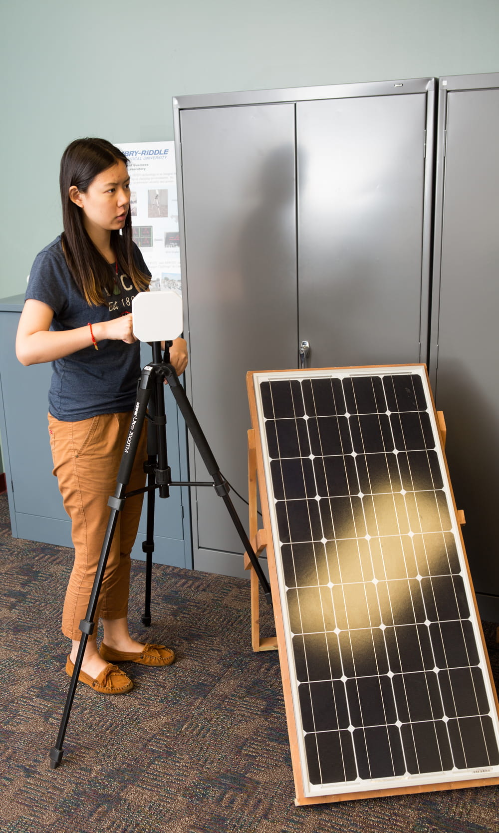 Woman with a solar panel.
