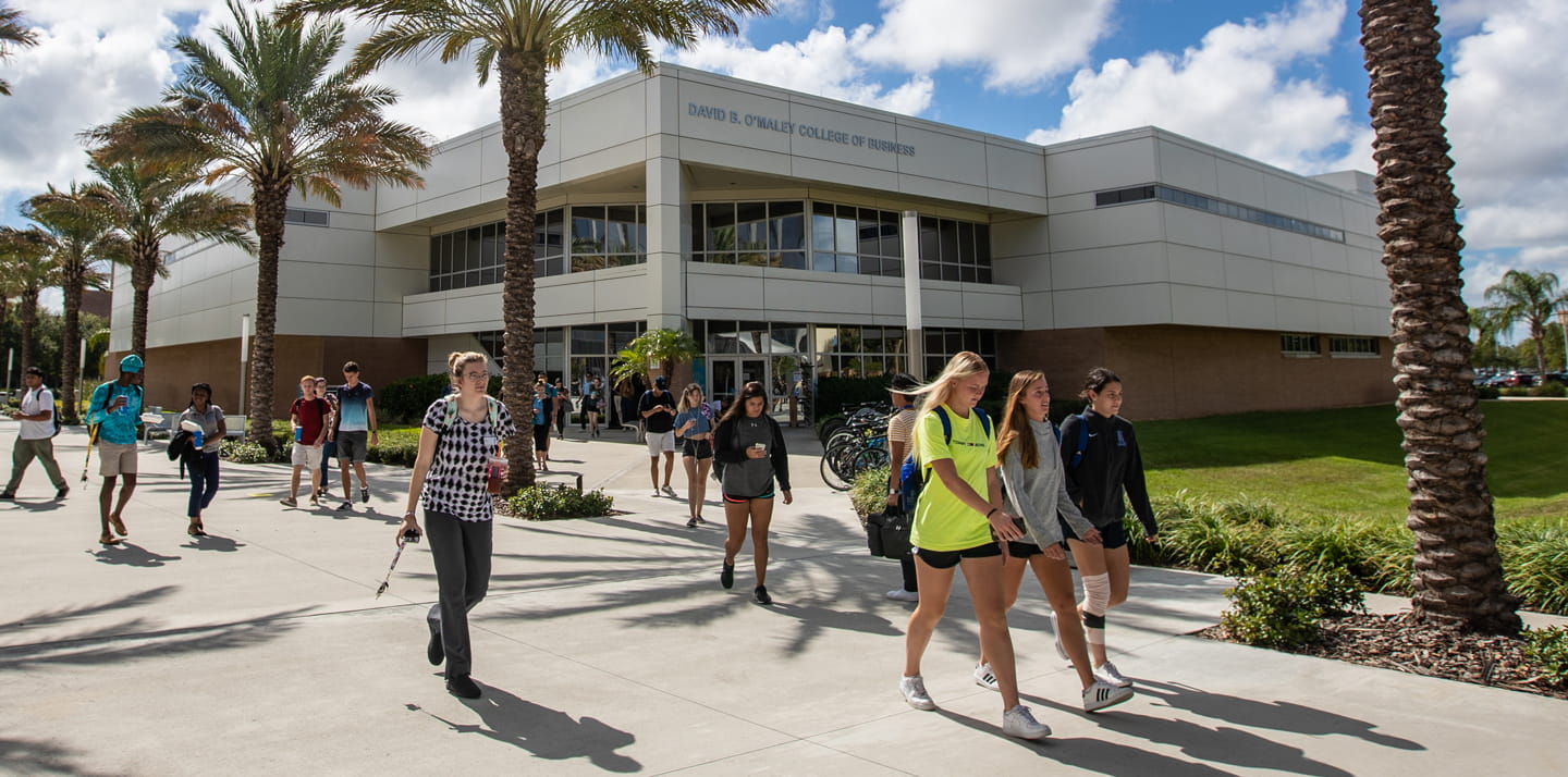 Students walk in front of the O'Maley College of Business