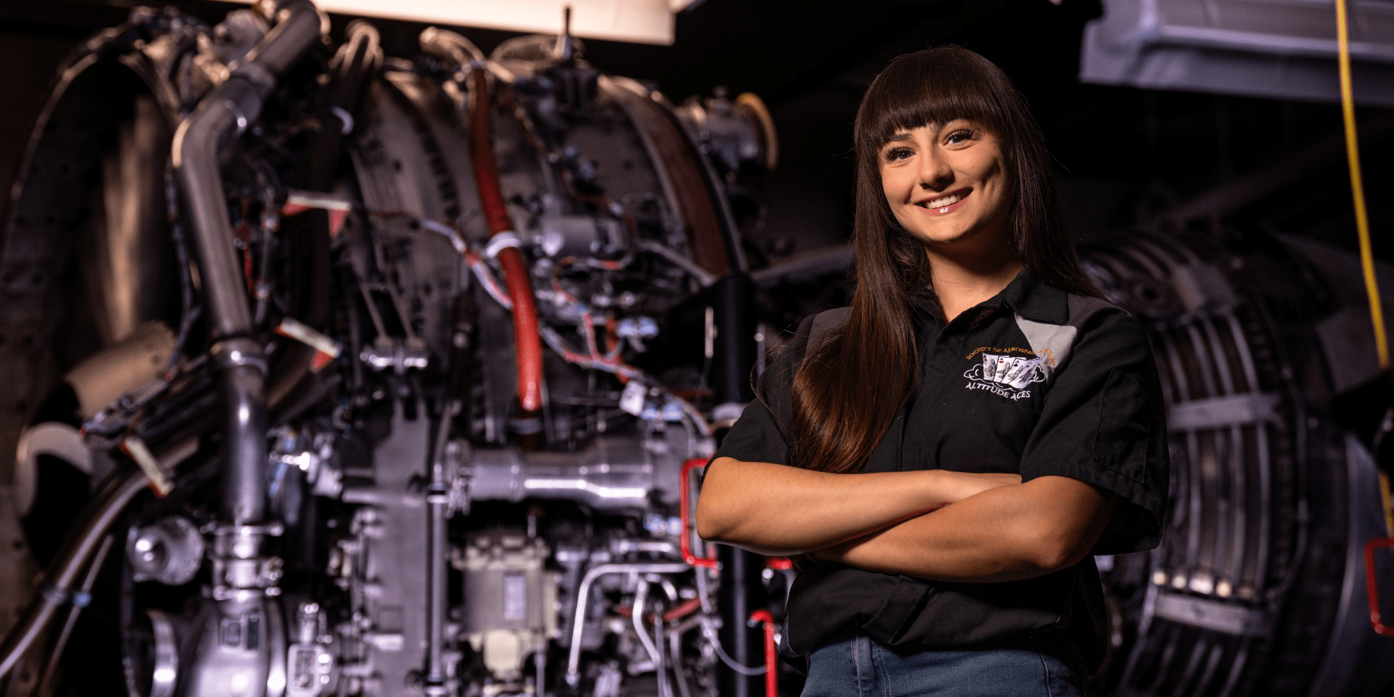 Sandra Acree stands in front of aviation equipment