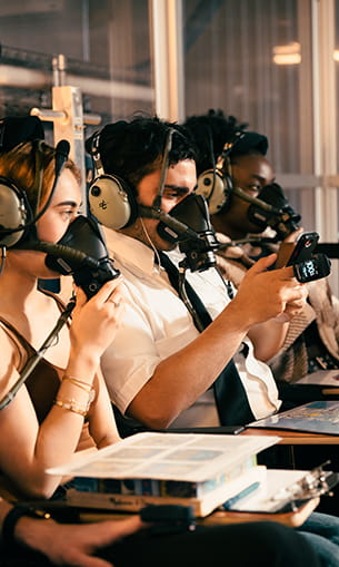 Embry-Riddle students wear oxygen masks and oxygen meters in the High-Altitude Normobaric Lab