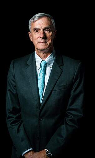 Dr. McCormick stands in a suit for a professional photo