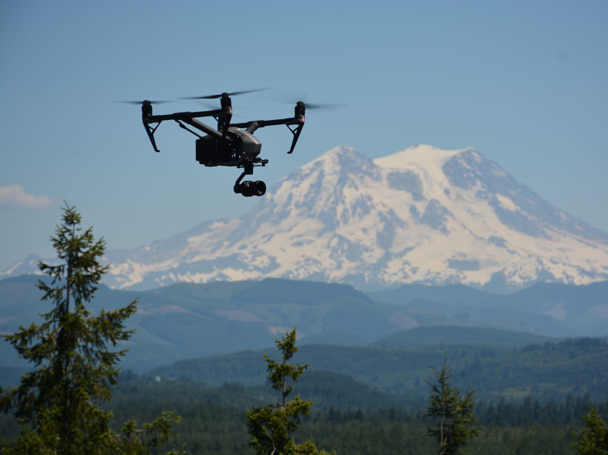 Drones flies with mountain in background
