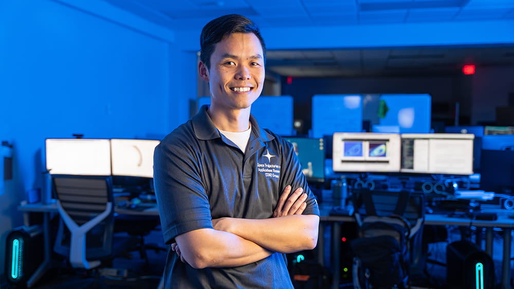Embry-Riddle student stands in a computer lab posing for a photo