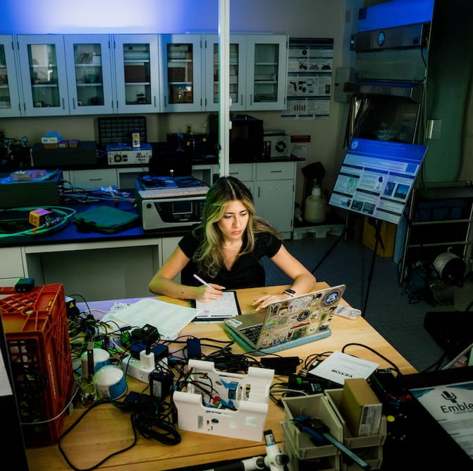 Dori Stein sits at a computer in an engineering lab