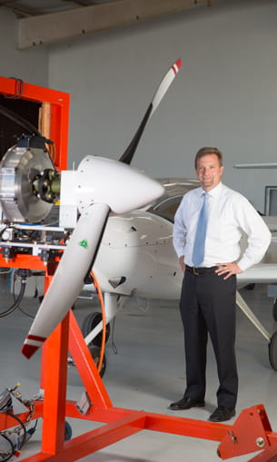 Professor next to a plane engine