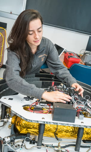 Woman wiring a satellite