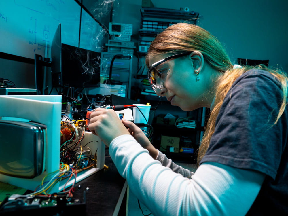 Woman works on an electrical project.