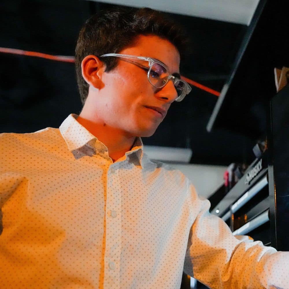Justin Fratto works with engineering equipment in a lab