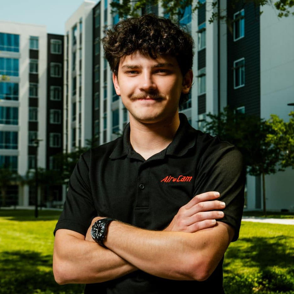 Noah Evans stands outside on the Daytona Beach Campus posing for a photo