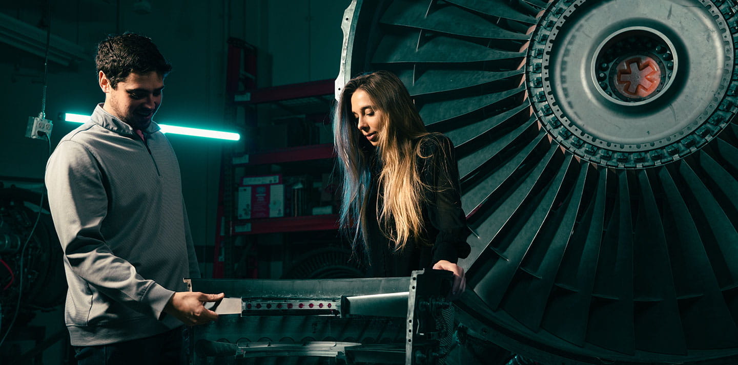 Two Embry-Riddle students look at plane equipment