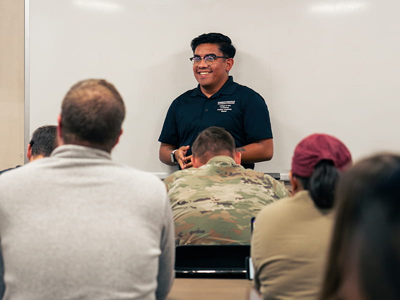 Embry-Riddle faculty member stands at the front of class presenting