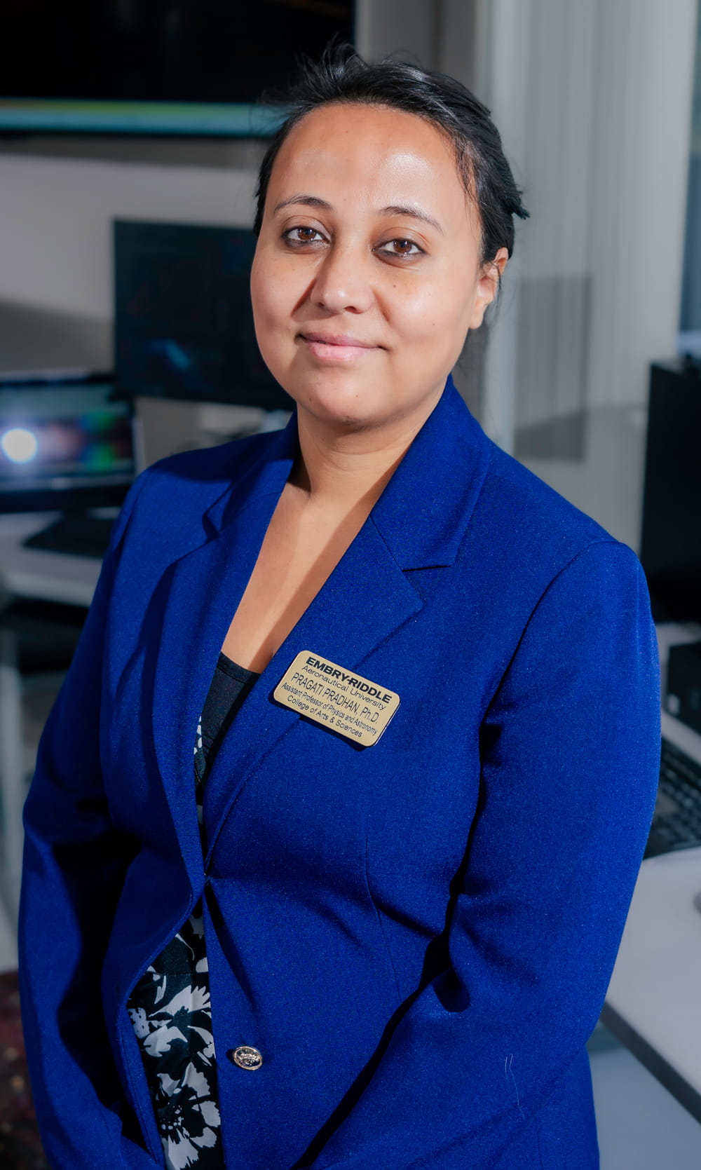 Professor Pradhan stands in a computer lab on the Prescott campus