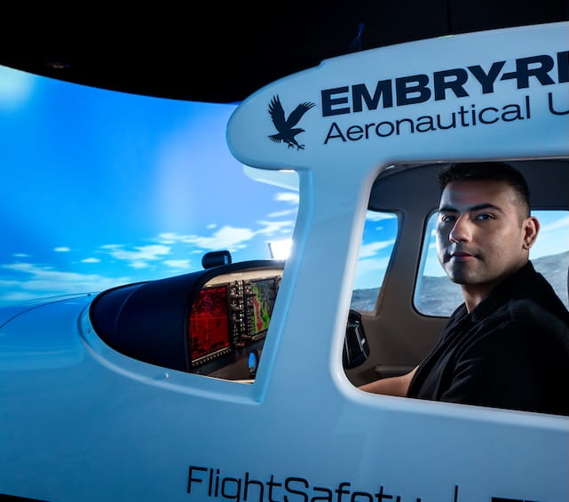 Embry-Riddle student sits in an aircraft simulator