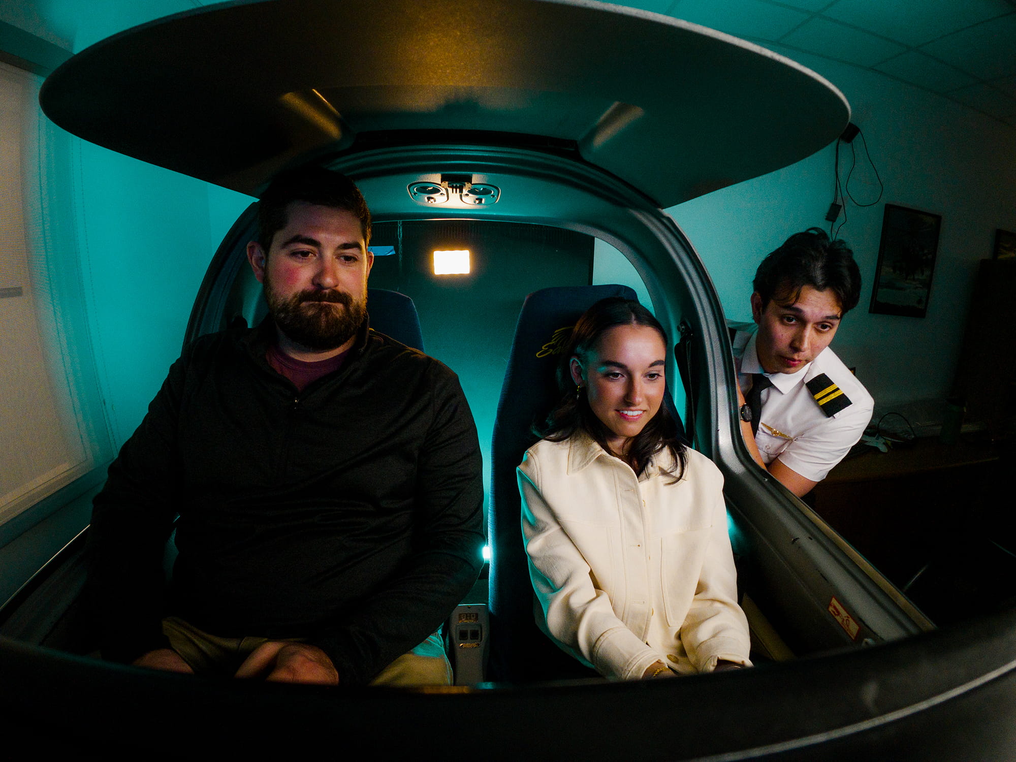 Two Embry-Riddle students sit in a simulator learning to fly