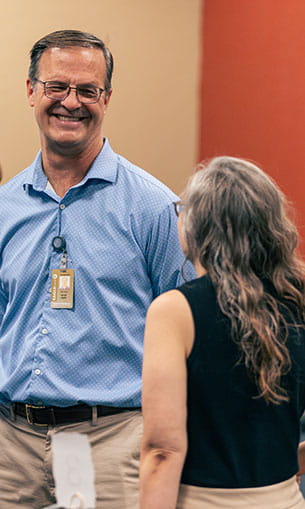 Two faculty members talk at the 2024 Years of Service Awards