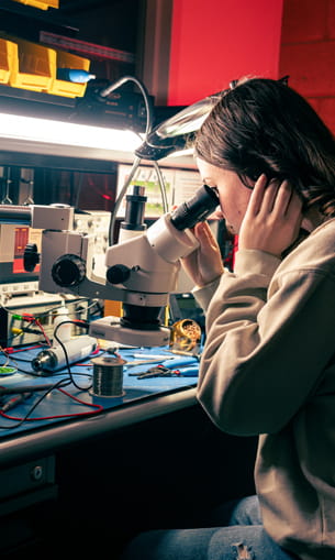 A person looking into a microscope.