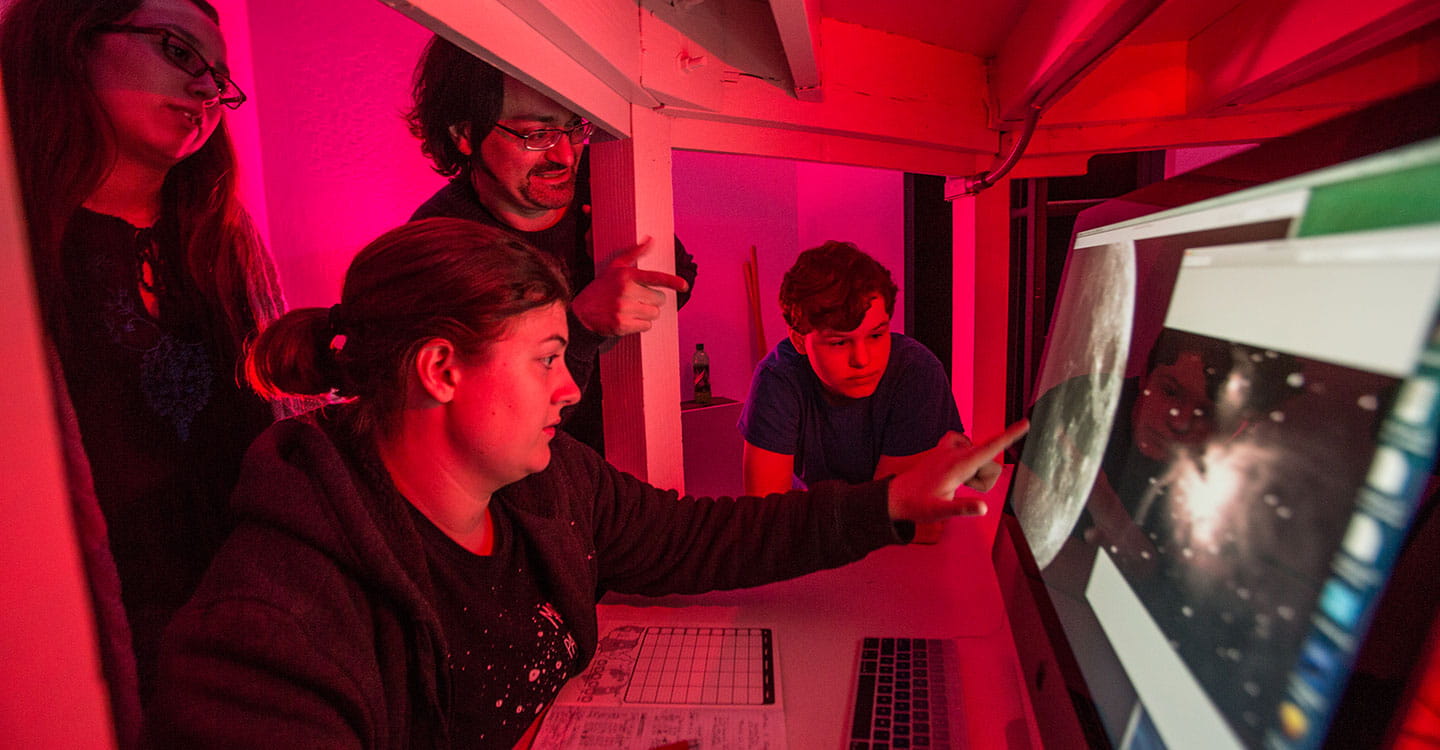 Students look at star systems and exoplanets inside the Observatory Facility at Embry-Riddle Aeronautical University in Prescott