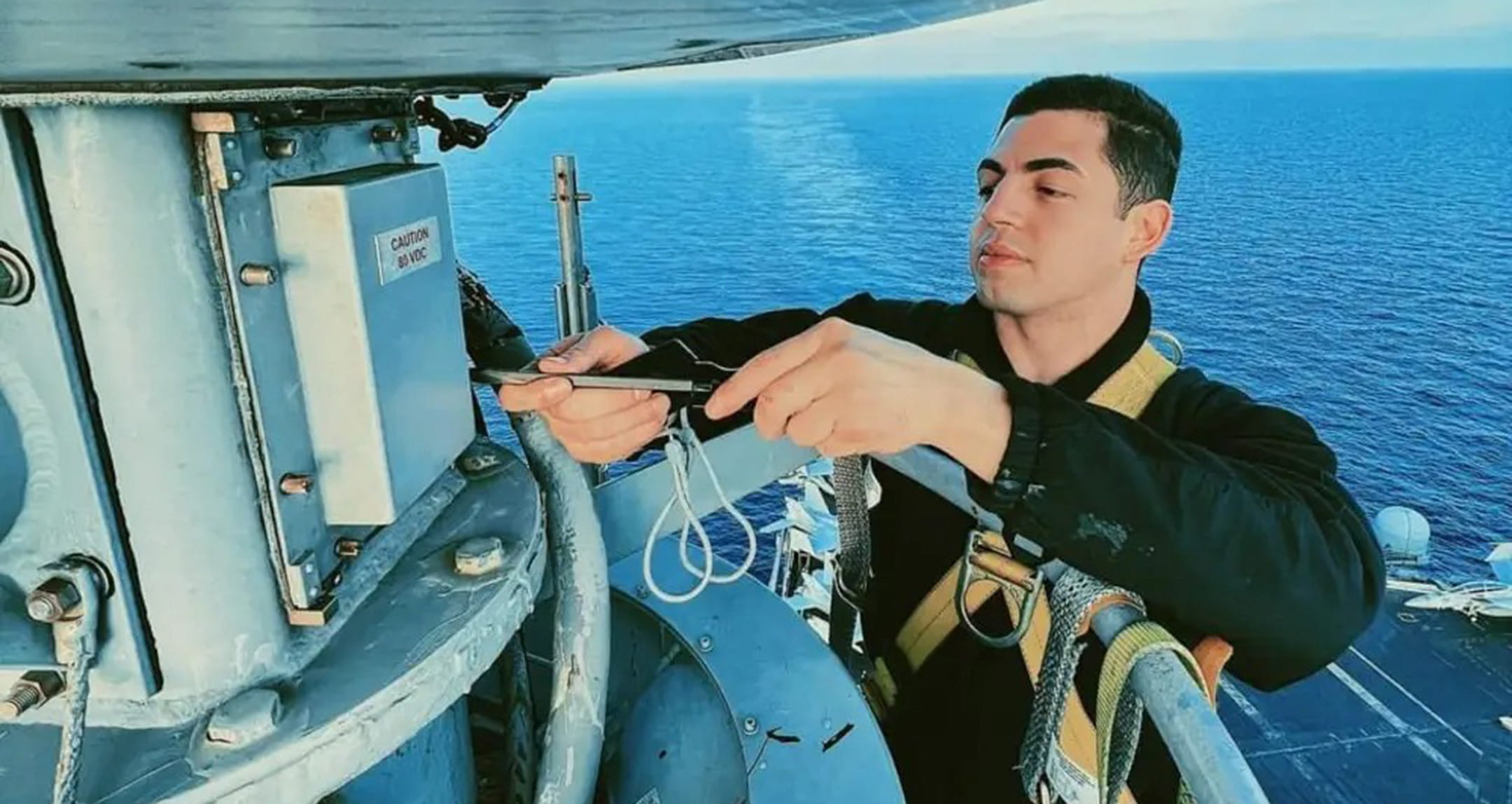 C.J. troubleshoots an issue with the USS George H.W. Bush’s Tactical Air Navigation System antenna while out at sea