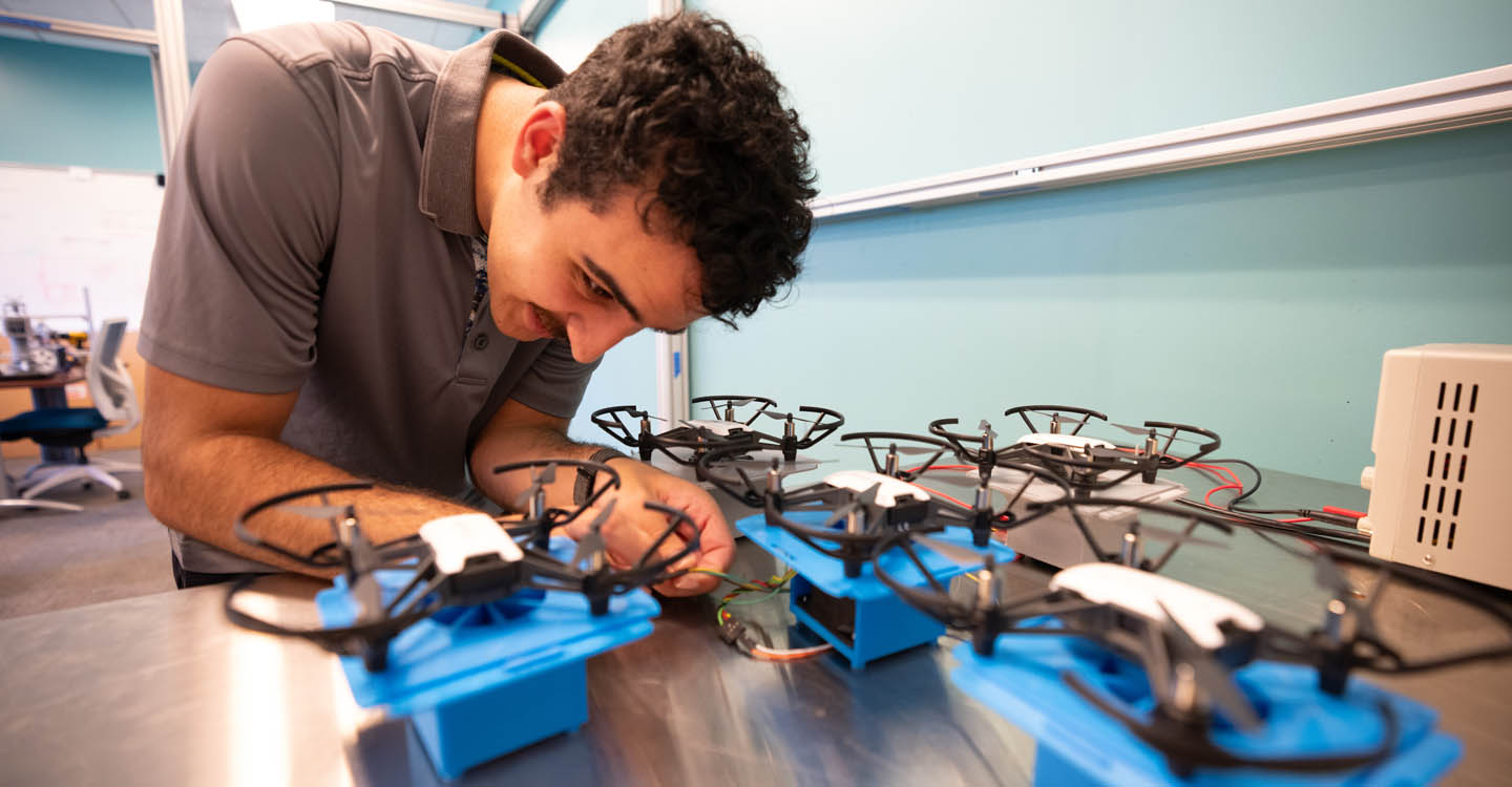 A person working on a set of drones.