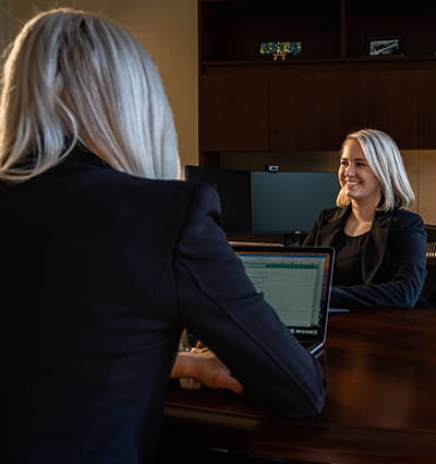Embry-Riddle student sits in an office across from a woman working on a laptop