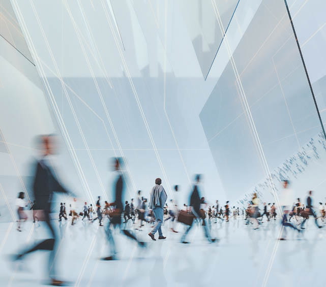 A group of people walking inside a building.
